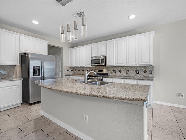 4315 Countrycrossing Dr, Spring, TX 77388 - kitchen with stainless steel appliances, decorative backsplash, white cabinetry, and recessed lighting