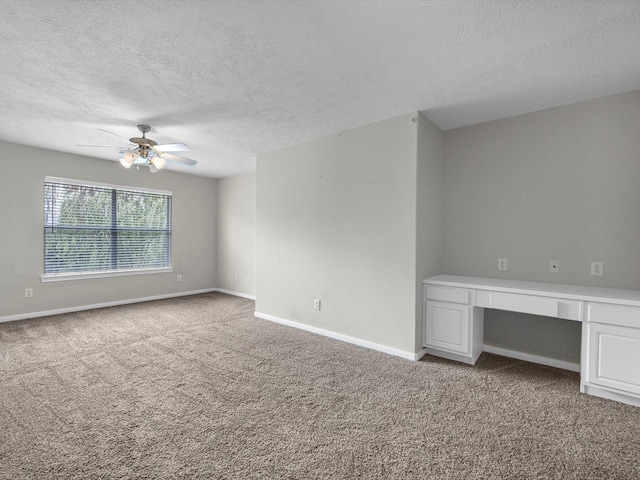 4315 Countrycrossing Dr, Spring, TX 77388 - unfurnished room with a textured ceiling, a ceiling fan, light carpet, and built in desk