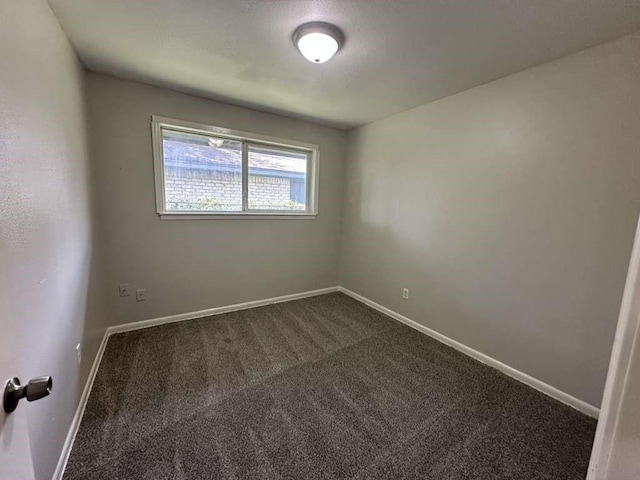6523 Hanley Ln, Houston, TX 77016 - unfurnished room featuring dark colored carpet and baseboards