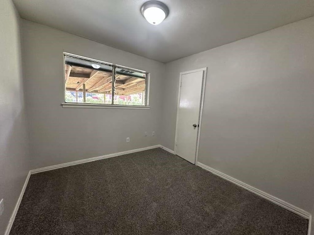 6523 Hanley Ln, Houston, TX 77016 - spare room with dark colored carpet and baseboards