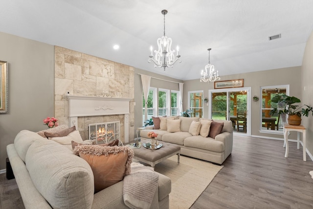 1518 Honea Egypt Rd, Magnolia, TX 77354 - living room with a chandelier, lofted ceiling, a tile fireplace, and wood finished floors