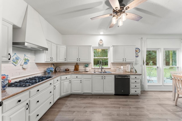 1518 Honea Egypt Rd, Magnolia, TX 77354 - kitchen featuring dishwasher, black gas stovetop, custom range hood, plenty of natural light, and recessed lighting
