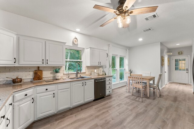 1518 Honea Egypt Rd, Magnolia, TX 77354 - kitchen with dishwasher, decorative backsplash, white cabinets, light wood-type flooring, and recessed lighting