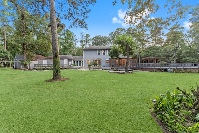 1518 Honea Egypt Rd, Magnolia, TX 77354 - view of green lawn featuring a deck and a storage shed