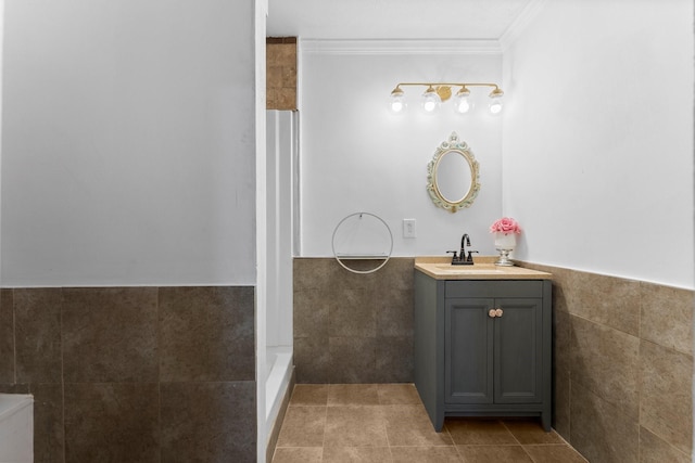 1518 Honea Egypt Rd, Magnolia, TX 77354 - bathroom with vanity, tile walls, crown molding, tile patterned floors, and wainscoting