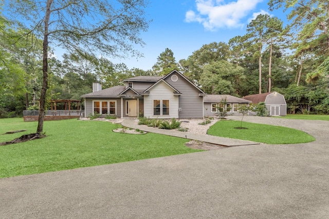 1518 Honea Egypt Rd, Magnolia, TX 77354 - ranch-style home with a chimney, driveway, and a front yard