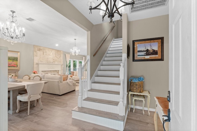 1518 Honea Egypt Rd, Magnolia, TX 77354 - stairway with a chandelier and wood finished floors