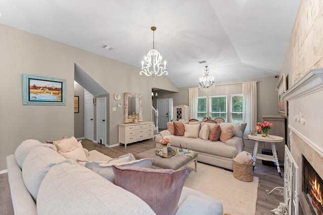 1518 Honea Egypt Rd, Magnolia, TX 77354 - living room featuring a chandelier, a fireplace, wood finished floors, and vaulted ceiling