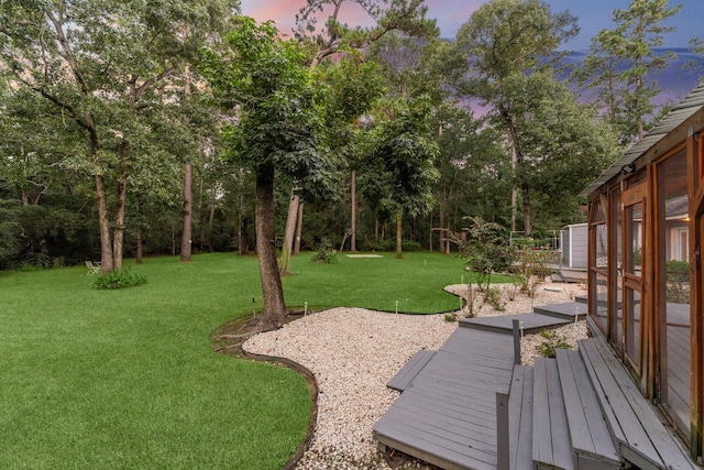 1518 Honea Egypt Rd, Magnolia, TX 77354 - yard at dusk featuring a yard, a deck, and view of scattered trees