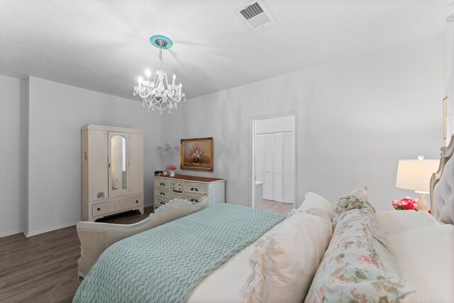 1518 Honea Egypt Rd, Magnolia, TX 77354 - bedroom featuring wood finished floors and a chandelier