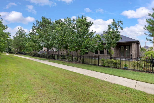 10005 Red Beadtree Pl, Conroe, TX 77385 - view of property hidden behind natural elements featuring french doors and brick siding