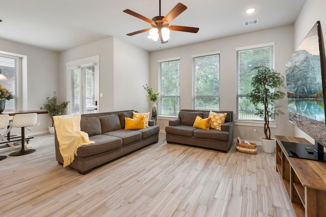 10005 Red Beadtree Pl, Conroe, TX 77385 - living room with healthy amount of natural light, light wood finished floors, a ceiling fan, and recessed lighting