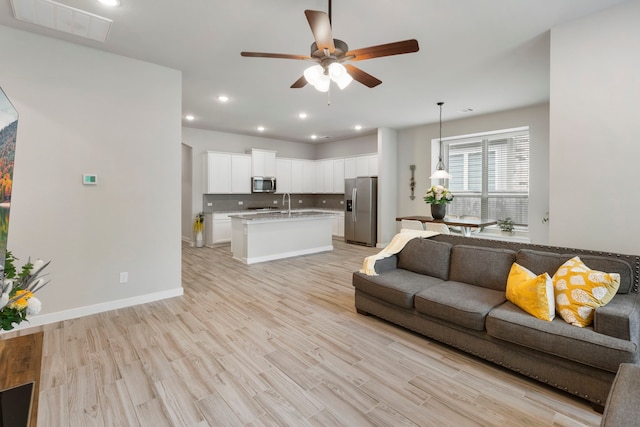 10005 Red Beadtree Pl, Conroe, TX 77385 - living area featuring ceiling fan, light wood-style flooring, and recessed lighting