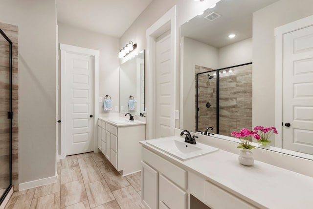10005 Red Beadtree Pl, Conroe, TX 77385 - bathroom featuring a shower stall, two vanities, and recessed lighting