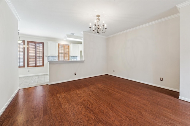 1606 Sutton St, Houston, TX 77006 - empty room featuring crown molding, a chandelier, and wood finished floors