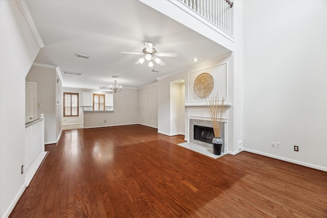 1606 Sutton St, Houston, TX 77006 - unfurnished living room featuring a chandelier, a tiled fireplace, a ceiling fan, wood finished floors, and crown molding