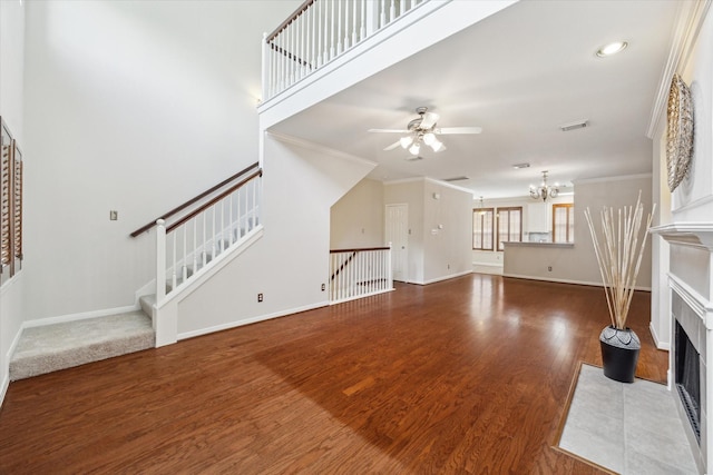 1606 Sutton St, Houston, TX 77006 - unfurnished living room featuring a fireplace, ceiling fan, wood finished floors, crown molding, and a chandelier