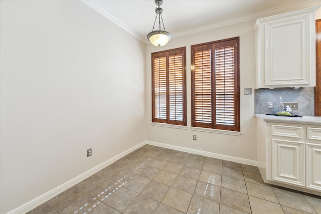 1606 Sutton St, Houston, TX 77006 - unfurnished dining area featuring crown molding and light tile patterned flooring