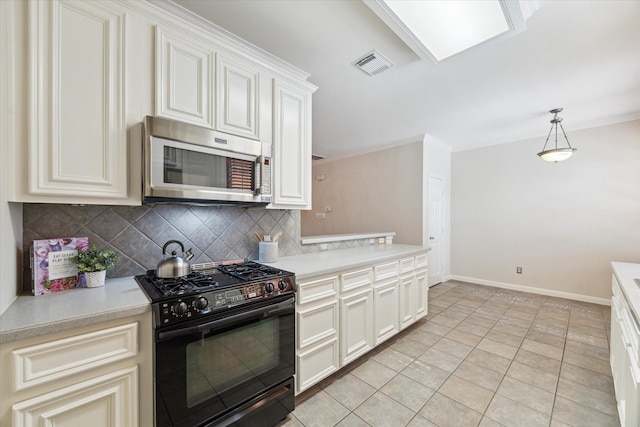 1606 Sutton St, Houston, TX 77006 - kitchen with black range with gas cooktop, stainless steel microwave, tasteful backsplash, light countertops, and light tile patterned flooring