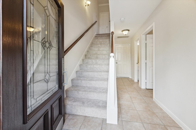 1606 Sutton St, Houston, TX 77006 - stairway featuring tile patterned floors and baseboards