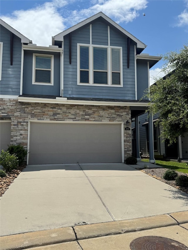 4727 Glen Isle Dr, Houston, TX 77009 - view of front facade featuring stone siding, concrete driveway, and an attached garage