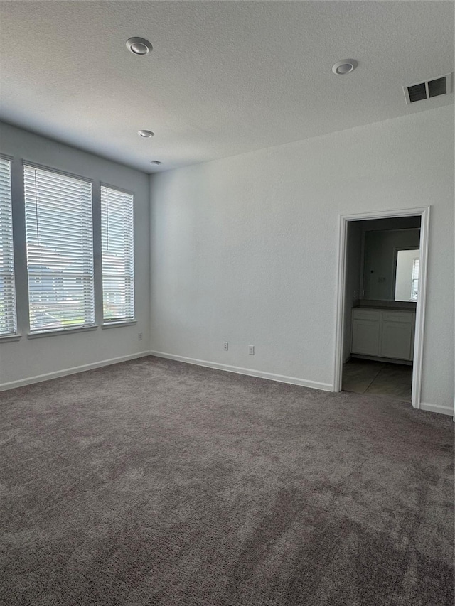 4727 Glen Isle Dr, Houston, TX 77009 - carpeted empty room featuring baseboards and a textured ceiling
