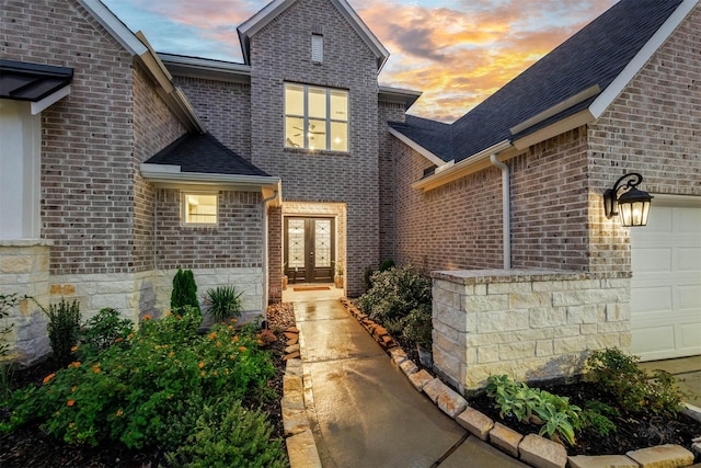 3239 Caney Dr, Katy, TX 77493 - property entrance featuring french doors, an attached garage, brick siding, and roof with shingles