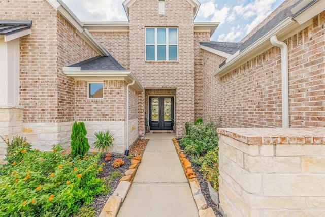 3239 Caney Dr, Katy, TX 77493 - property entrance with french doors, brick siding, and roof with shingles