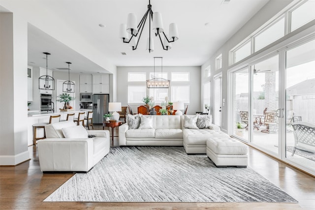 3239 Caney Dr, Katy, TX 77493 - living room with a chandelier and wood finished floors