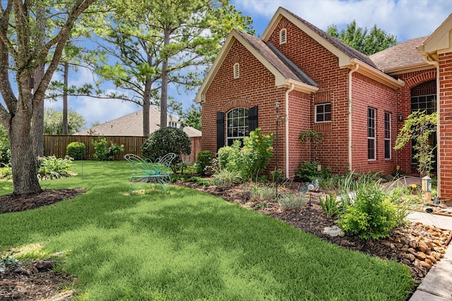 1607 N Primavera Dr, Pearland, TX 77581 - view of side of home with brick siding and roof with shingles
