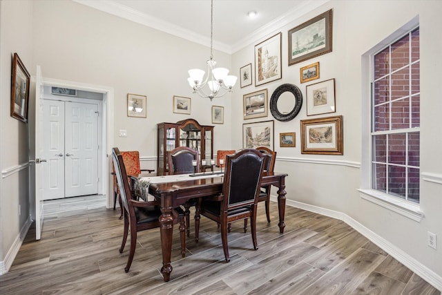 1607 N Primavera Dr, Pearland, TX 77581 - dining room featuring a chandelier, ornamental molding, wood finished floors, and a high ceiling