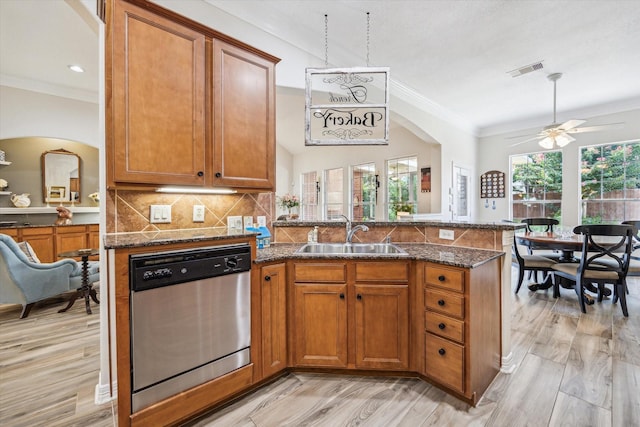 1607 N Primavera Dr, Pearland, TX 77581 - kitchen featuring dishwasher, crown molding, brown cabinetry, a peninsula, and dark stone counters