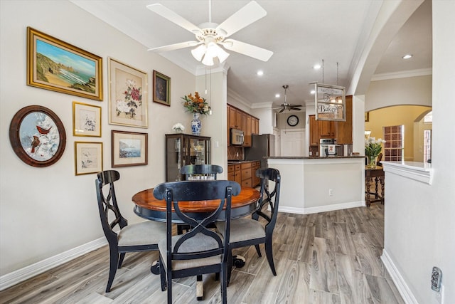 1607 N Primavera Dr, Pearland, TX 77581 - dining space with a ceiling fan, light wood-style flooring, arched walkways, ornamental molding, and recessed lighting