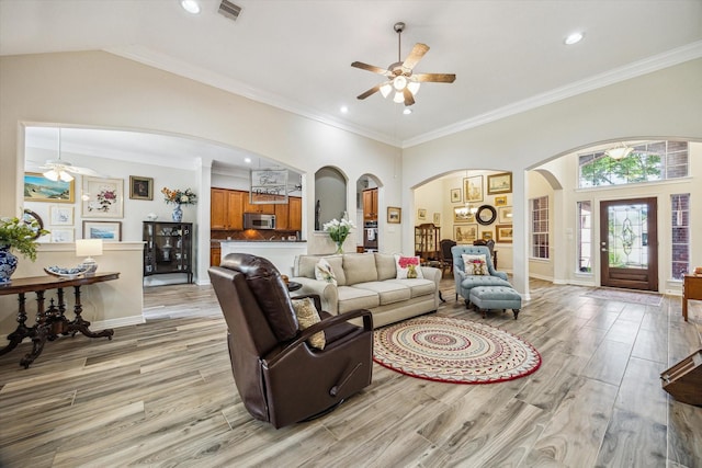 1607 N Primavera Dr, Pearland, TX 77581 - living area with arched walkways, ceiling fan, light wood finished floors, recessed lighting, and crown molding
