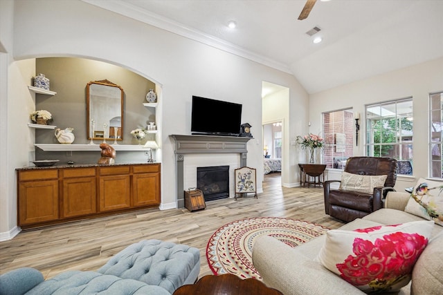 1607 N Primavera Dr, Pearland, TX 77581 - living area featuring ornamental molding, light wood finished floors, a glass covered fireplace, vaulted ceiling, and recessed lighting