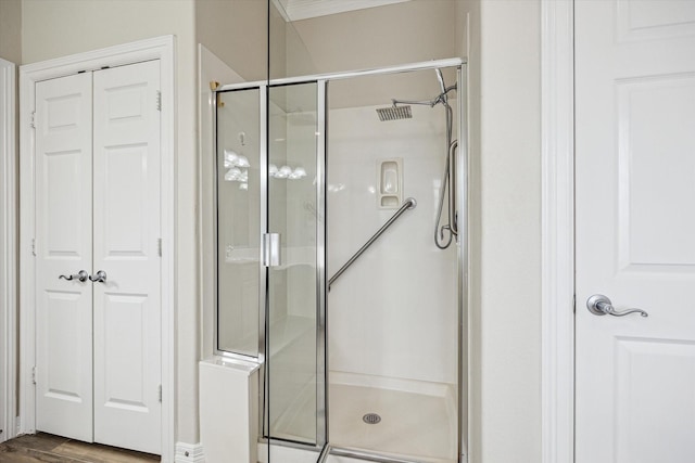 1607 N Primavera Dr, Pearland, TX 77581 - bathroom featuring a stall shower, wood finished floors, and a closet