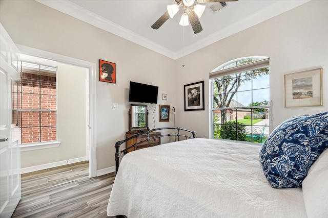 1607 N Primavera Dr, Pearland, TX 77581 - bedroom featuring crown molding, wood finished floors, multiple windows, and a ceiling fan