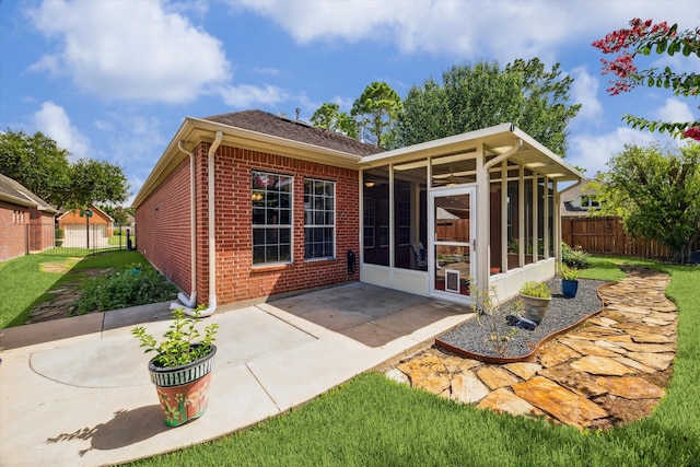 1607 N Primavera Dr, Pearland, TX 77581 - back of house with a sunroom, brick siding, and a patio area