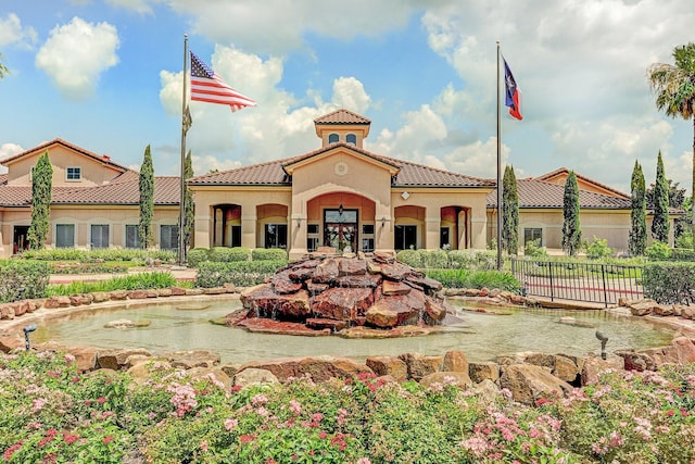 1607 N Primavera Dr, Pearland, TX 77581 - view of building exterior with a small pond