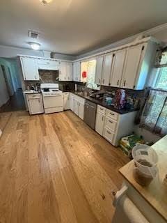 701 Lee Ave, Anahuac, TX 77514 - kitchen featuring light wood-style floors, white range oven, stainless steel dishwasher, white cabinetry, and dark countertops