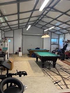 701 Lee Ave, Anahuac, TX 77514 - playroom with pool table and lofted ceiling