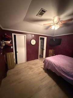 701 Lee Ave, Anahuac, TX 77514 - bedroom with ornamental molding and ceiling fan