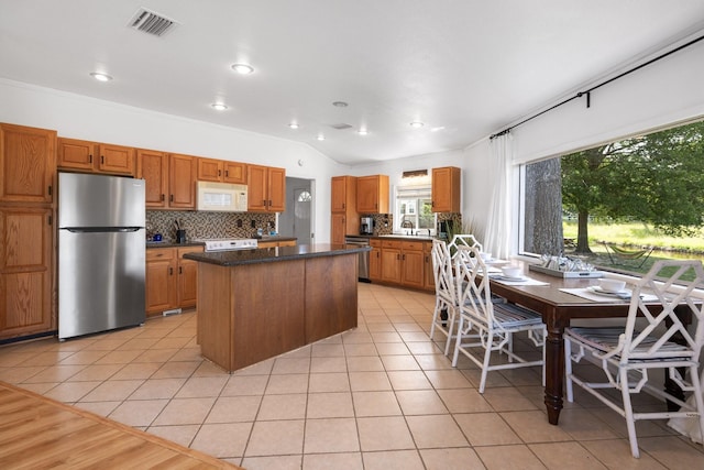20559 Red Bud Ct, Thornton, TX 76687 - kitchen featuring stainless steel appliances, a kitchen island, tasteful backsplash, light tile patterned floors, and recessed lighting