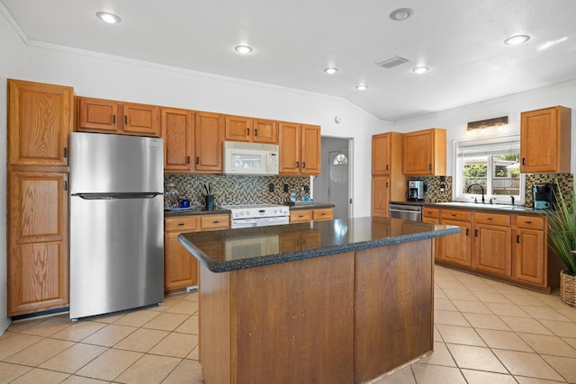 20559 Red Bud Ct, Thornton, TX 76687 - kitchen with appliances with stainless steel finishes, a center island, tasteful backsplash, light tile patterned floors, and crown molding