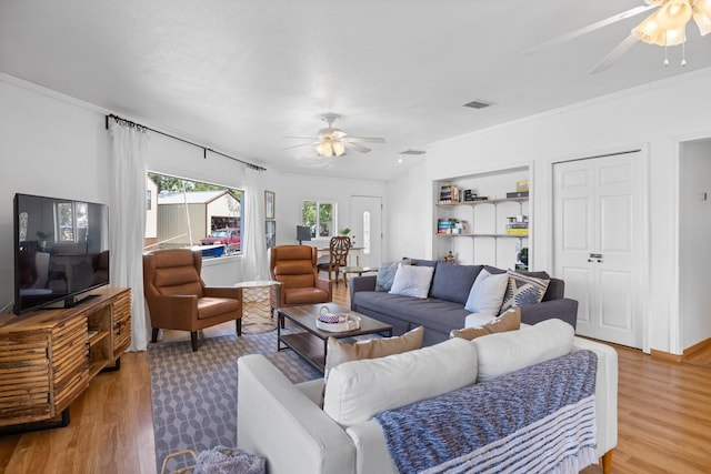 20559 Red Bud Ct, Thornton, TX 76687 - living room featuring ceiling fan, light wood-style floors, and crown molding