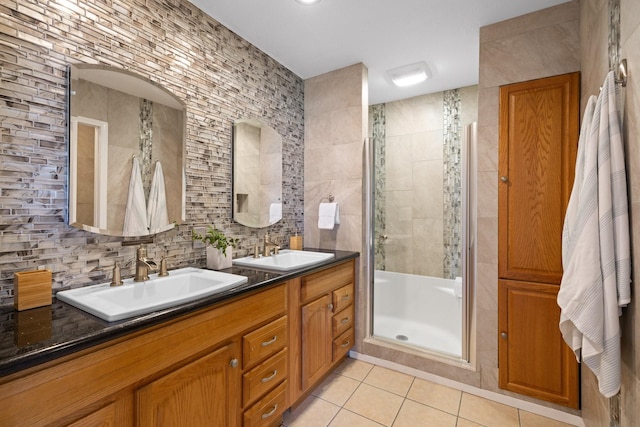 20559 Red Bud Ct, Thornton, TX 76687 - full bathroom featuring tile patterned flooring, tile walls, a tile shower, double vanity, and backsplash
