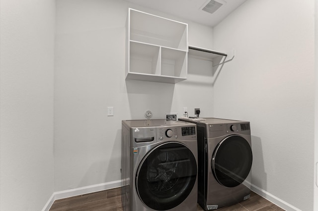 29622 Sterling Knoll Dr, Fulshear, TX 77441 - laundry room featuring independent washer and dryer and dark wood-type flooring