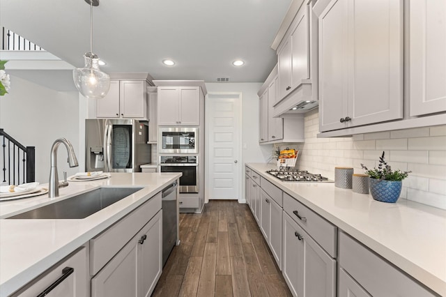 29622 Sterling Knoll Dr, Fulshear, TX 77441 - kitchen featuring appliances with stainless steel finishes, recessed lighting, light countertops, hanging light fixtures, and dark wood-style floors