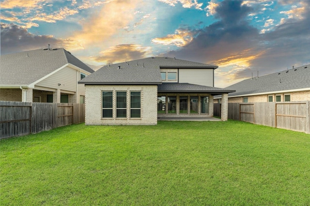 29622 Sterling Knoll Dr, Fulshear, TX 77441 - rear view of property with a fenced backyard, a shingled roof, brick siding, and a patio area