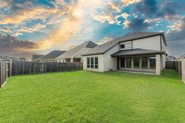 29622 Sterling Knoll Dr, Fulshear, TX 77441 - back of house featuring a fenced backyard, brick siding, and a shingled roof
